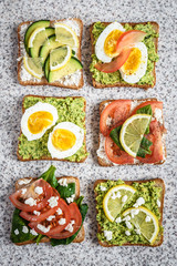 Healthy avocado and egg toasts. Toast, avocado, egg, tomatoes, spinach, cheese Feta, lemon. Organic healthy food. Clean healthy eating