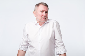 Fototapeta premium Uncertain upset pensive male hesitates what to buy.