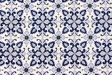 Beautiful traditional Portuguese blue and white tiles covering the building wall. Azulejo. Background, wallpaper.