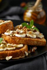French cinnamon toast with banana, nuts and hazelnut, honey.