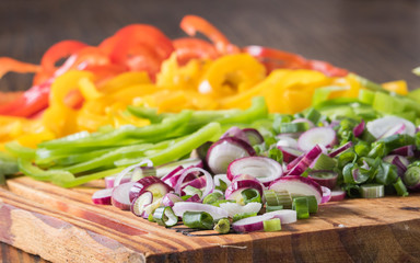 green onion and red, green and yellow chili peppers cut in julienne