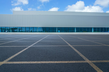 Road asphalt pavement and modern factory warehouse..