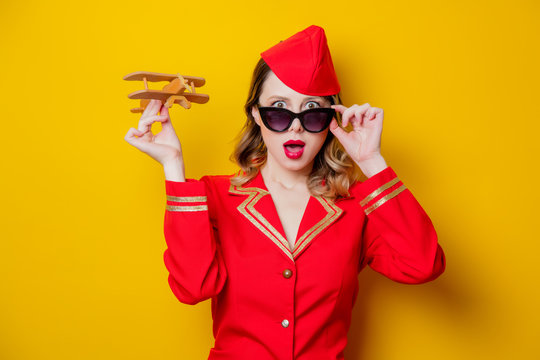 Charming Vintage Stewardess Wearing In Red Uniform With Airplane