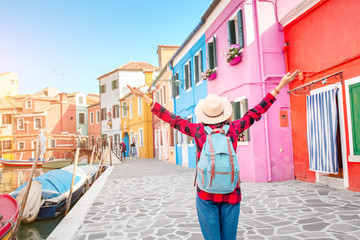 Happy asian traveler woman having fun on well known Burano island near Venice. Travel and vacation in Italy concept - obrazy, fototapety, plakaty