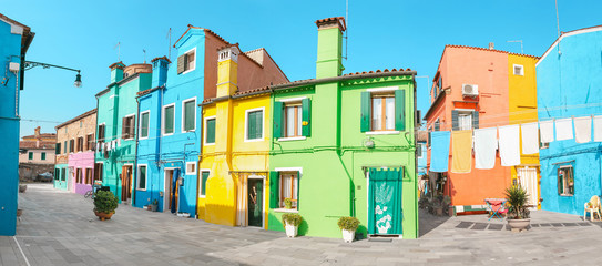 Colorful Facade of a houses in Burano with drying clothes