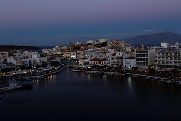 Fototapeta na wymiar View over a beautiful, picturesque town of Agios Nikolaos, Crete, Grete and small Voulismeni lake and a port.