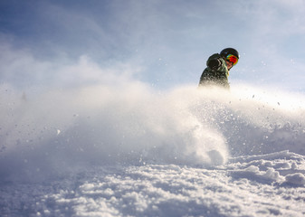 Snowboarder rides through the camera. Snow explosion