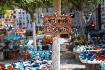 Handmade in Crete sign on a board attached to a pole.