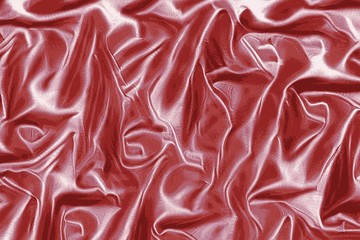 Red satin texture of a silk dress fabric very soft