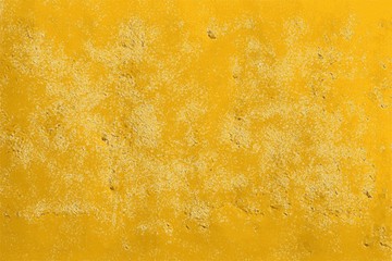 Texture of a yellow concrete wall marked and weathered