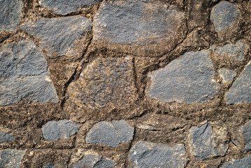 A stone wall made of large stones. Background.
