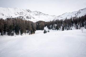 Fototapeta na wymiar Mountain skiing - panoramic view at the ski slopes Aosta Valley, Italy .