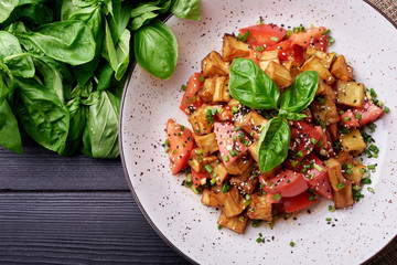 Homemade italian food with tomato, green onion, basil on wood background. Top view. Copy space.