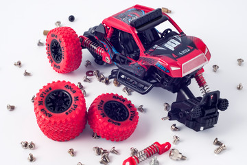 Disassembled car and scattered parts. Broken toy