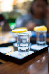 shot glass filled with tequila service with lemon and salt