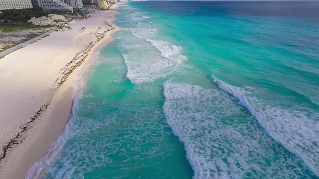 Aerial view on coast of Caribbean sea, waves on water. Most beautiful beach in Cancun, Mexico