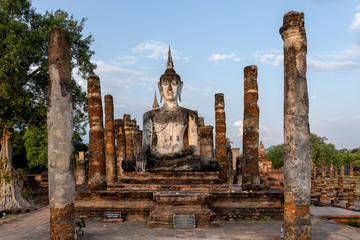 Fototapeta na wymiar Buddha Statue in Sukhothai Historical Park in Thailand, The Sukhothai Historical Park ruins are one of Thailand's most impressive World Heritage Sites. 