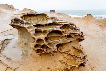 Honeycomb Weathering rock at Yehliu Geopark in Taiwan. Honeycombed rocks refer to the rocks that...