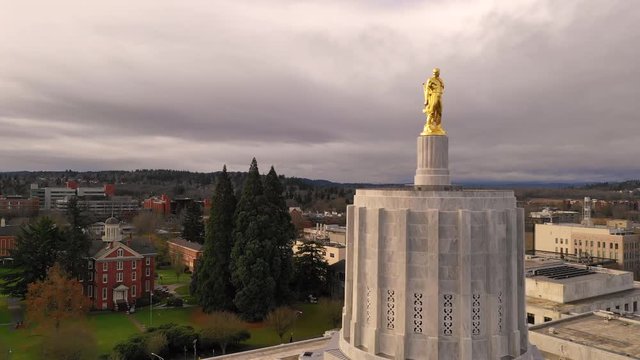 Dawn Sun Shines Through Clouds at The State Capital Building in Salem