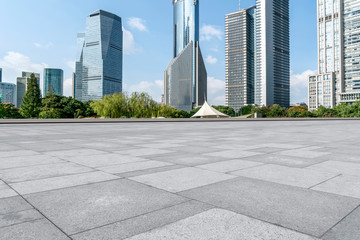 Fototapeta premium Empty square floor tiles and skyline of modern urban buildings in Shanghai..