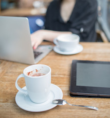 young adult businessperson working on laptop with coffee pro pad and pencil on the table