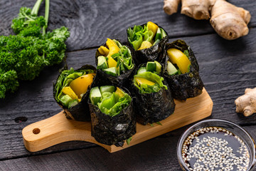 Set of healthy vegetarian vegetables sushi rolls with cucumber, pepper and green salad at decorated...