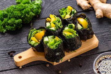 Set of healthy vegetarian vegetables sushi rolls with cucumber, pepper and green salad at decorated...