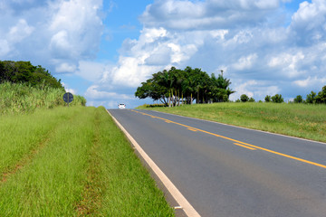 Perspective of highway with isolated car on the horizon