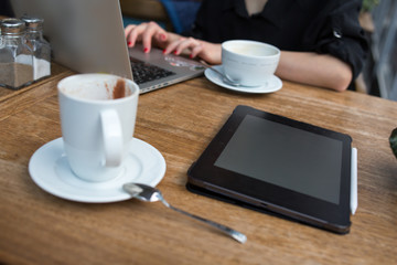 young adult businessperson working on laptop with coffee pro pad and pencil on the table