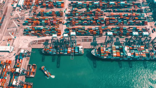 HONG KONG - MAY 2018: Aerial timelapse view of port, containers and fixed cranes from above, fast work activities.