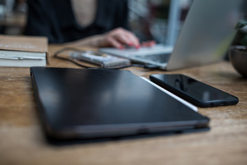 young adult businessperson working on laptop with coffee pro pad and pencil on the table