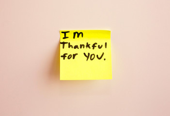 I am thankful for you note reminder yellow sticker on a wall, close up. Happy Mother's Day.