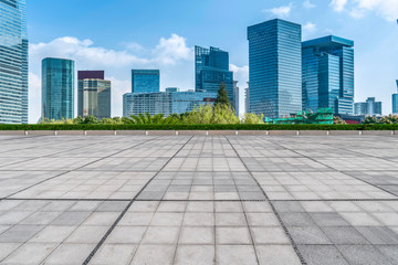 Empty square floor tiles and skyline of modern urban buildings in Shanghai..