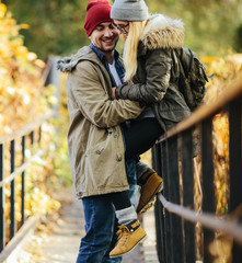 Two young travel couple walking on bridge