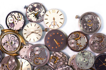 Details of clocks and mechanisms for repair, restoration and maintenance on a white background.
