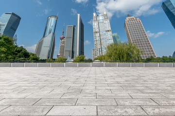Fototapeta premium Empty square floor tiles and skyline of modern urban buildings in Shanghai..