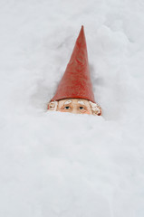 Gnome is covered in winter snow drift