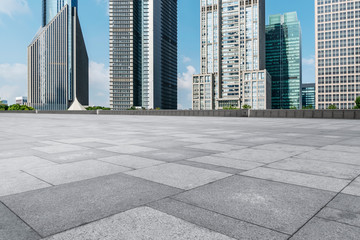 Fototapeta premium Empty square floor tiles and skyline of modern urban buildings in Shanghai..