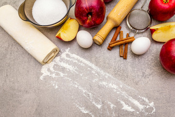 Apple pie ingredients baking concept. Fresh apples with cinnamon, flour, sugar, eggs. Cooking...