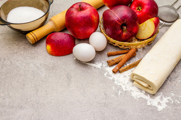 Apple pie ingredients baking concept. Fresh apples with cinnamon, flour, sugar, eggs. Cooking...