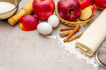 Apple pie ingredients baking concept. Fresh apples with cinnamon, flour, sugar, eggs. Cooking...
