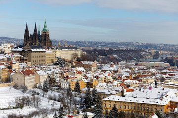 Snowy Prague City with gothic Castle from Hill Petrin in the sunny Day, Czech republic