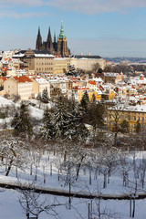 Snowy Prague City with gothic Castle from Hill Petrin in the sunny Day, Czech republic
