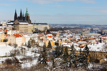 Snowy Prague City with gothic Castle from Hill Petrin in the sunny Day, Czech republic