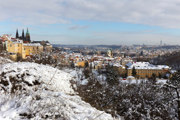 Snowy Prague City with gothic Castle from Hill Petrin in the sunny Day, Czech republic