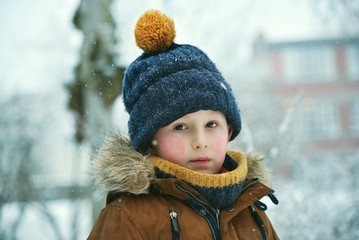 Thinking little boy at winter