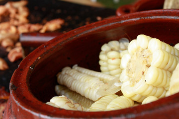 Peruvian yellow corn called 'Choclo' in handmade ceramic pot