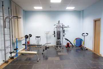 Fototapeta na wymiar empty gym for fitness and bodybuilding with fitness equipment and dumbbells.