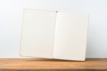 Perspective view of kraft notebook on wood floor