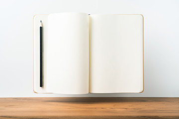 Perspective view of kraft notebook on wood floor